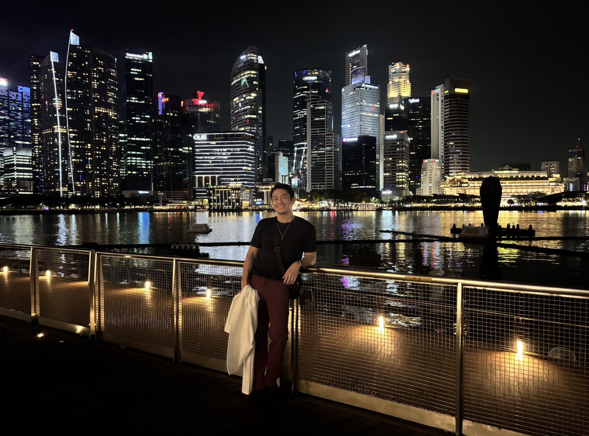 Ezekiel Vicente standing beside the Singapore skyline at night